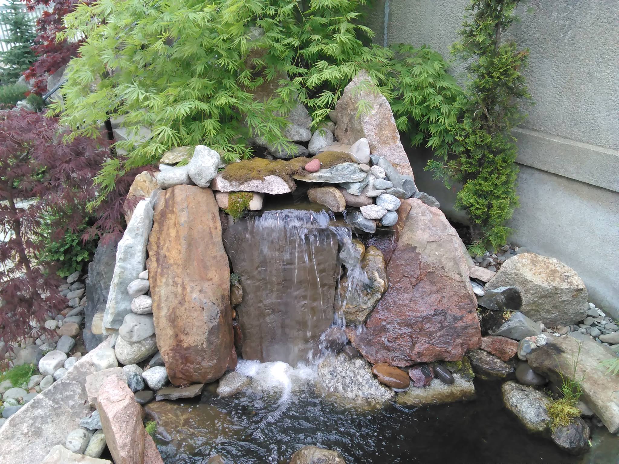 Stone bubbler hardscape installation Patio Courtyard Settings Maine